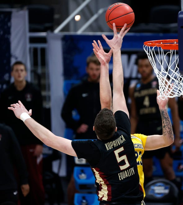 Florida State Seminoles center Balsa Koprivica (5) blocks Michigan Wolverines forward Brandon Johns Jr. (23) during the Sweet Sixteen round of the 2021 NCAA Tournament on Sunday, March 28, 2021, at Bankers Life Fieldhouse in Indianapolis, Ind.