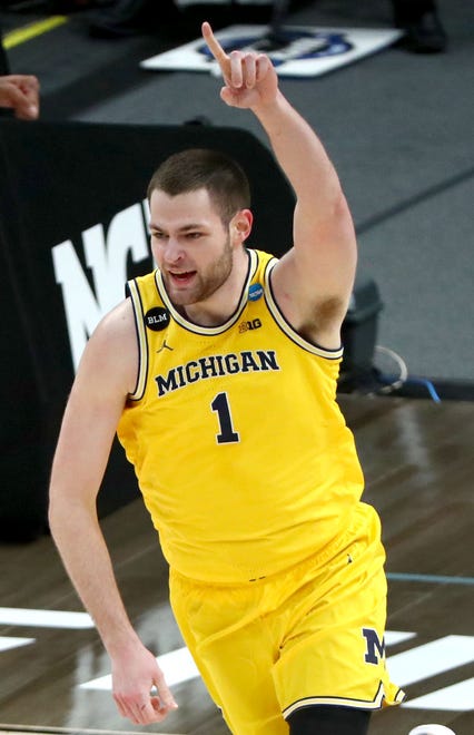 Michigan Wolverines center Hunter Dickinson (1) reacts after a dunk during the Sweet Sixteen round of the 2021 NCAA Tournament on Sunday, March 28, 2021, at Bankers Life Fieldhouse in Indianapolis, Ind.