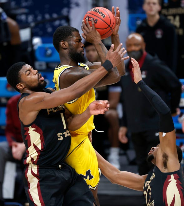 Michigan Wolverines guard Chaundee Brown (15) grabs the rebound over Florida State Seminoles forward Malik Osborne (10) and Florida State Seminoles guard M.J. Walker (23) during the Sweet Sixteen round of the 2021 NCAA Tournament on Sunday, March 28, 2021, at Bankers Life Fieldhouse in Indianapolis, Ind.