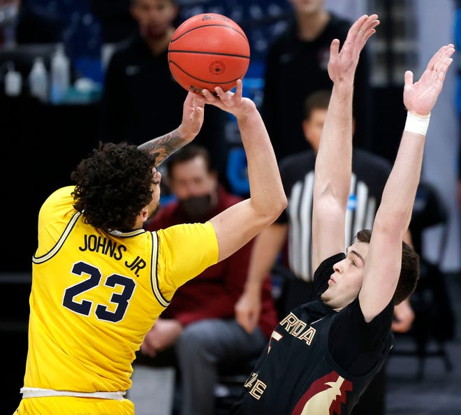 Florida State Seminoles center Balsa Koprivica (5) fouls Michigan Wolverines forward Brandon Johns Jr. (23) during the Sweet Sixteen round of the 2021 NCAA Tournament on Sunday, March 28, 2021, at Bankers Life Fieldhouse in Indianapolis, Ind.
