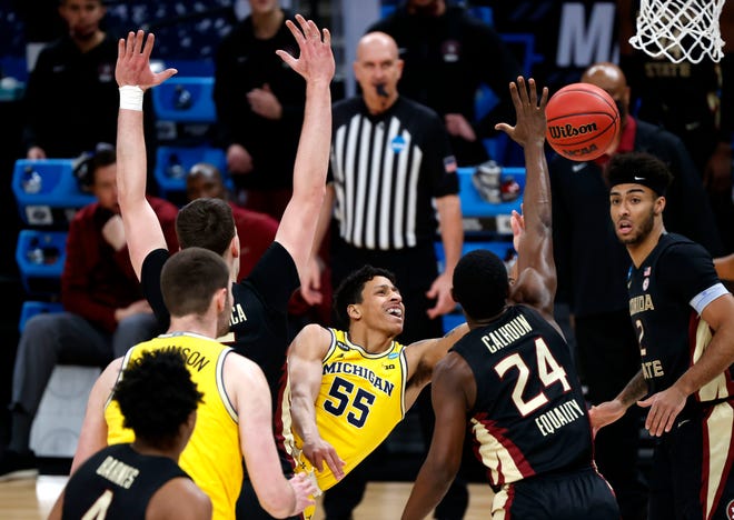 Michigan Wolverines guard Eli Brooks (55) tosses up a shot against Florida State during the Sweet Sixteen round of the 2021 NCAA Tournament on Sunday, March 28, 2021, at Bankers Life Fieldhouse in Indianapolis, Ind.
