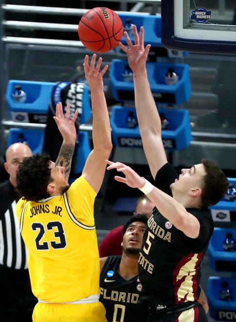 Florida State Seminoles center Balsa Koprivica (5) blocks a shot by Michigan Wolverines forward Brandon Johns Jr. (23) during the Sweet Sixteen round of the 2021 NCAA Tournament on Sunday, March 28, 2021, at Bankers Life Fieldhouse in Indianapolis, Ind.