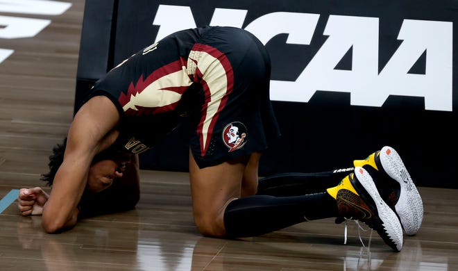 Florida State Seminoles guard Scottie Barnes (4) buries his head in the ground after a foul during the Sweet Sixteen round of the 2021 NCAA Tournament on Sunday, March 28, 2021, at Bankers Life Fieldhouse in Indianapolis, Ind.