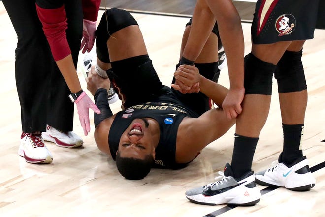 Florida State Seminoles guard M.J. Walker (23) lies on the court with an injury during the Sweet Sixteen round of the 2021 NCAA Tournament on Sunday, March 28, 2021, at Bankers Life Fieldhouse in Indianapolis, Ind.
