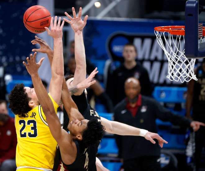 Florida State Seminoles guard Scottie Barnes (4) blocks Michigan Wolverines forward Brandon Johns Jr. (23) during the Sweet Sixteen round of the 2021 NCAA Tournament on Sunday, March 28, 2021, at Bankers Life Fieldhouse in Indianapolis, Ind.