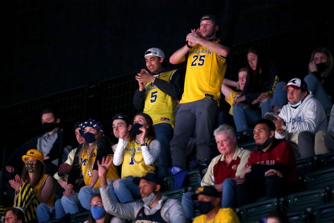 Michigan fans cheer as their team takes on Florida State during the Sweet Sixteen round of the 2021 NCAA Tournament on Sunday, March 28, 2021, at Bankers Life Fieldhouse in Indianapolis, Ind.