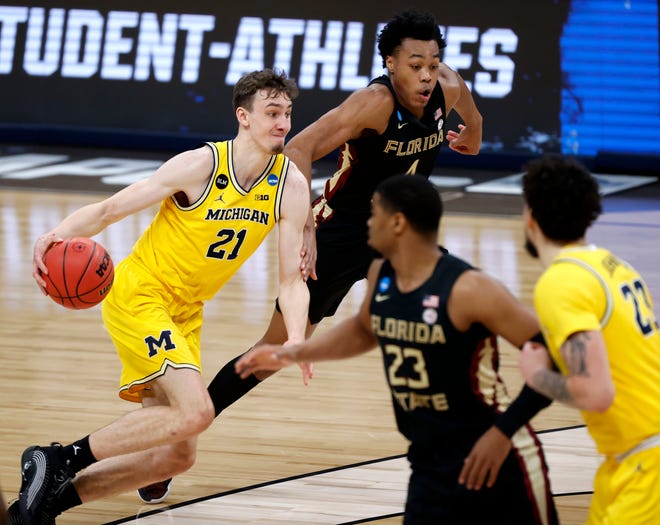 Michigan Wolverines guard Franz Wagner (21) drives past Florida State Seminoles guard Scottie Barnes (4) during the Sweet Sixteen round of the 2021 NCAA Tournament on Sunday, March 28, 2021, at Bankers Life Fieldhouse in Indianapolis, Ind.