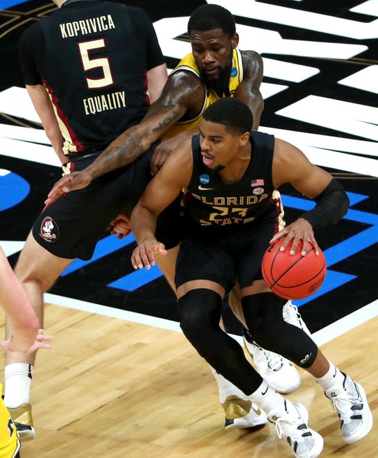 Florida State Seminoles guard M.J. Walker (23) moves past Michigan Wolverines guard Chaundee Brown (15) during the Sweet Sixteen round of the 2021 NCAA Tournament on Sunday, March 28, 2021, at Bankers Life Fieldhouse in Indianapolis, Ind.