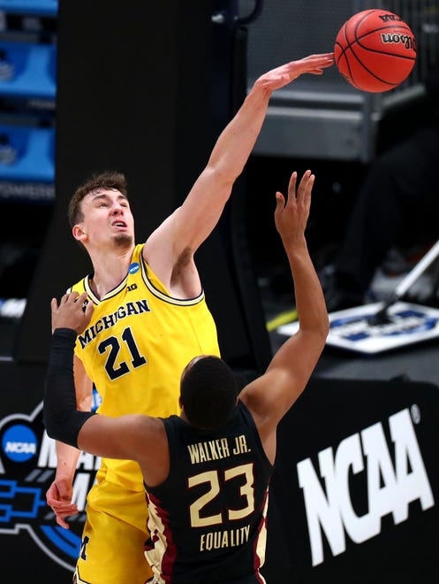 Michigan Wolverines guard Franz Wagner (21) blocks a shot by Florida State Seminoles guard M.J. Walker (23) during the Sweet Sixteen round of the 2021 NCAA Tournament on Sunday, March 28, 2021, at Bankers Life Fieldhouse in Indianapolis, Ind.
