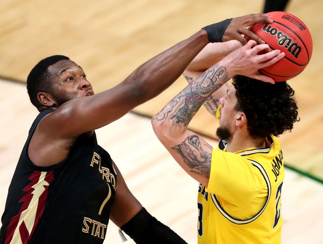 Florida State Seminoles forward RaiQuan Gray (1) defends against Michigan Wolverines forward Brandon Johns Jr. (23) during the Sweet Sixteen round of the 2021 NCAA Tournament on Sunday, March 28, 2021, at Bankers Life Fieldhouse in Indianapolis, Ind.