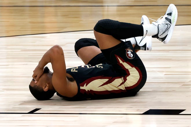 Florida State Seminoles guard M.J. Walker (23) lies on the court with an injury during the Sweet Sixteen round of the 2021 NCAA Tournament on Sunday, March 28, 2021, at Bankers Life Fieldhouse in Indianapolis, Ind.